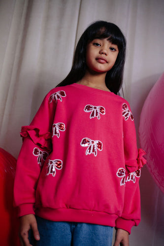 Donkerroze meisjessweater met glinsterende strikjes van Daily Brat – City Notes Collectie | Ontdek Daily Brat bij Little Fashion Addict