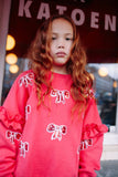 Donkerroze meisjessweater met glinsterende strikjes van Daily Brat – City Notes Collectie | Ontdek Daily Brat bij Little Fashion Addict