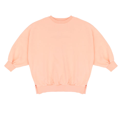 Pippa Sweater Peach Orange van Jenest – abrikooskleurige oversized meisjes sweater met bloemenprint op de rug | Ontdek Jenest bij Little Fashion Addict