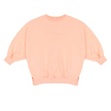 Pippa Sweater Peach Orange van Jenest – abrikooskleurige oversized meisjes sweater met bloemenprint op de rug | Ontdek Jenest bij Little Fashion Addict