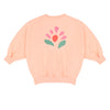 Pippa Sweater Peach Orange van Jenest – abrikooskleurige oversized meisjes sweater met bloemenprint op de rug | Ontdek Jenest bij Little Fashion Addict