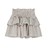 Wit Leonie rokje met zwart vierkantenpatroon van We Are Kids. | Verkrijgbaar bij Little Fashion Addict