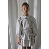 Wit Leonie rokje met zwart vierkantenpatroon van We Are Kids. | Verkrijgbaar bij Little Fashion Addict